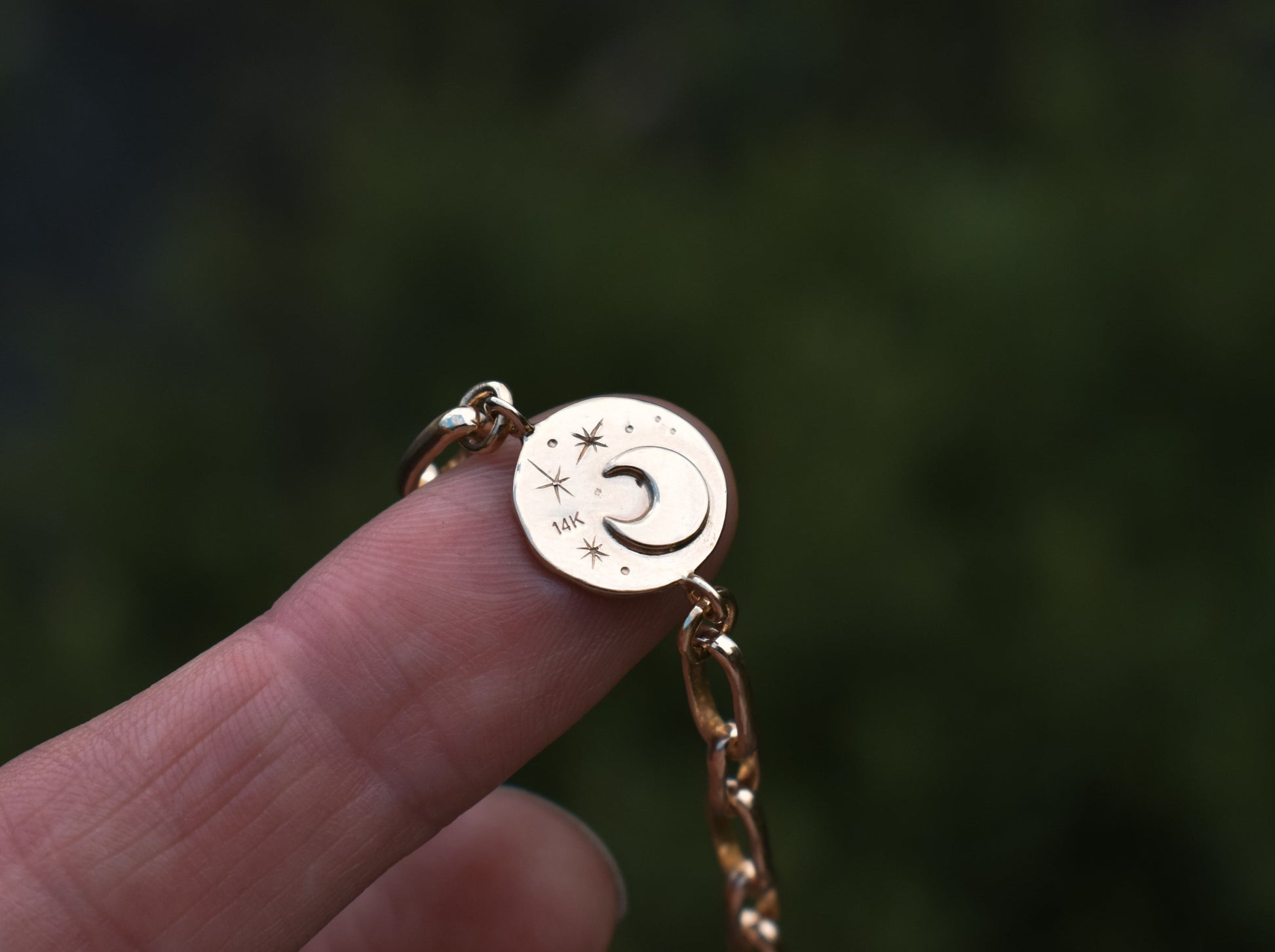 hand-engraved starry sky and crescent moon charm on heavy gold link bracelet